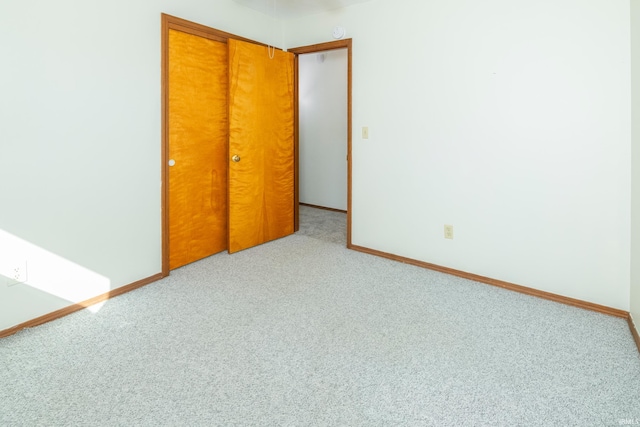 unfurnished bedroom with a closet and carpet