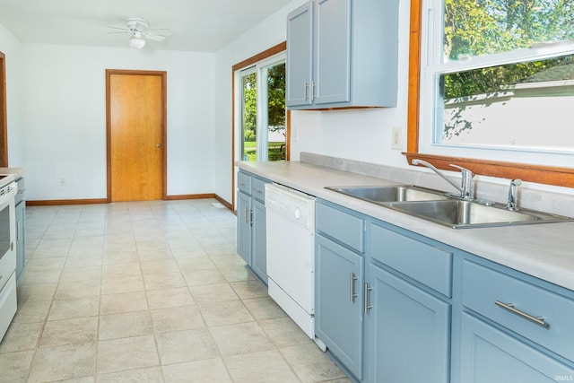 kitchen featuring light tile patterned flooring, blue cabinets, ceiling fan, sink, and dishwasher