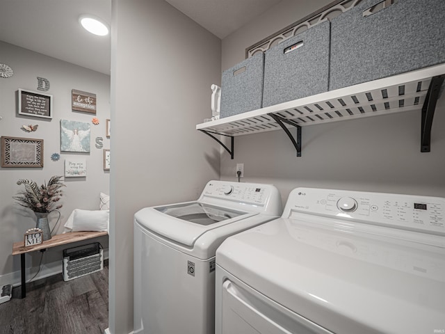 washroom featuring dark wood-type flooring and washing machine and dryer