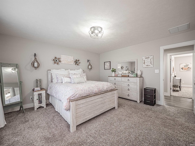 bedroom with carpet and a textured ceiling