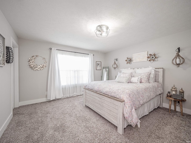 bedroom with light colored carpet and a textured ceiling