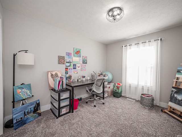 home office with carpet floors and a textured ceiling