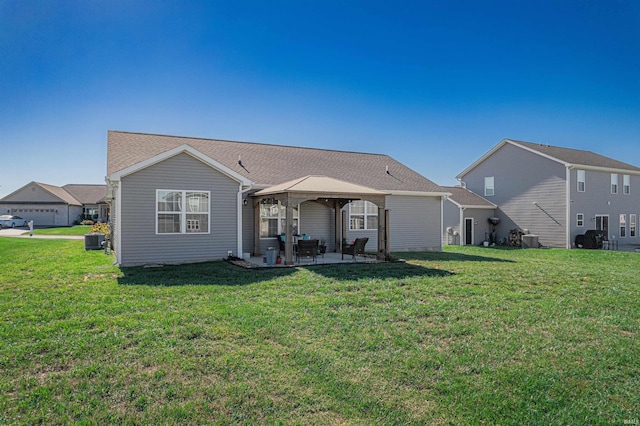 back of house with central AC, a yard, a patio area, and a garage