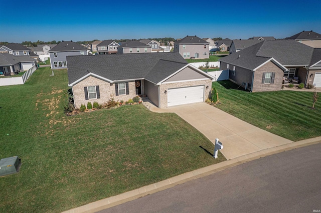 view of front of property featuring a front lawn and a garage