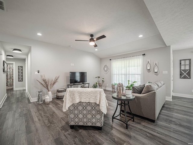 living room with lofted ceiling, dark hardwood / wood-style flooring, a textured ceiling, and ceiling fan