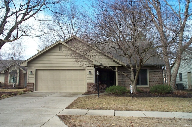 ranch-style house featuring an attached garage, cooling unit, concrete driveway, and brick siding