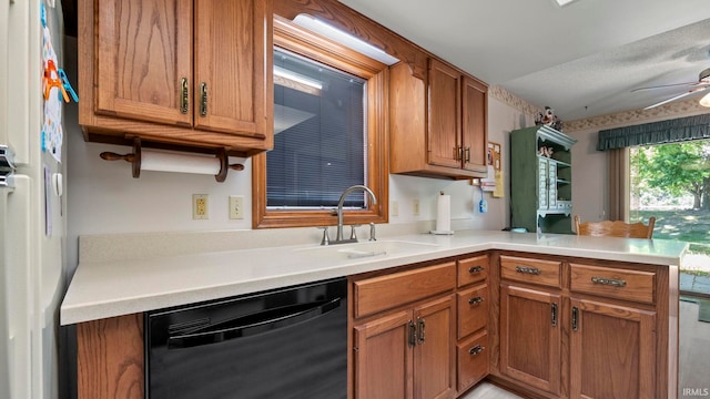 kitchen featuring dishwasher, kitchen peninsula, sink, and ceiling fan