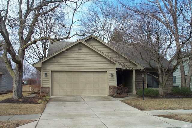 ranch-style home featuring concrete driveway, a garage, and brick siding