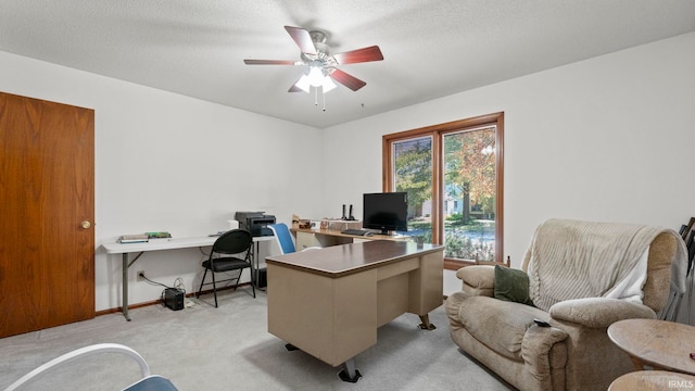 home office with ceiling fan, light colored carpet, baseboards, and a textured ceiling