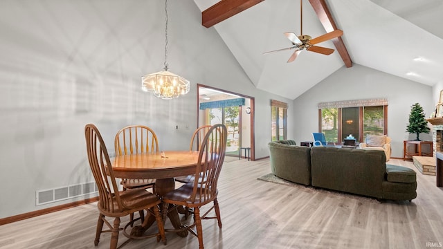 dining area with ceiling fan with notable chandelier, light wood-type flooring, high vaulted ceiling, and beam ceiling