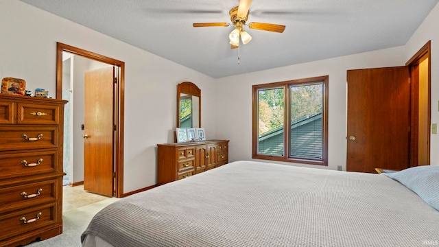 bedroom with light carpet, a textured ceiling, and ceiling fan