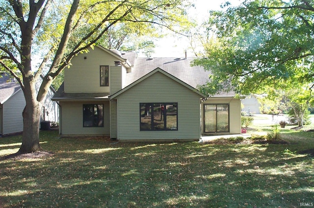 back of property featuring a yard