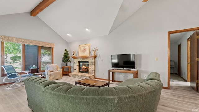 living area with baseboards, a brick fireplace, light wood-style floors, beamed ceiling, and high vaulted ceiling