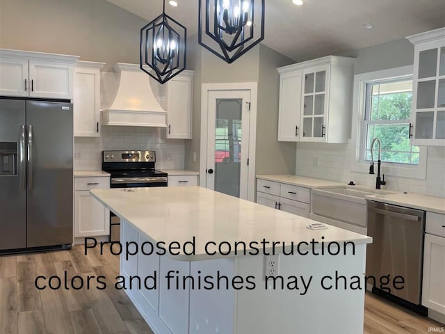 kitchen featuring white cabinetry, light wood-type flooring, appliances with stainless steel finishes, and custom exhaust hood