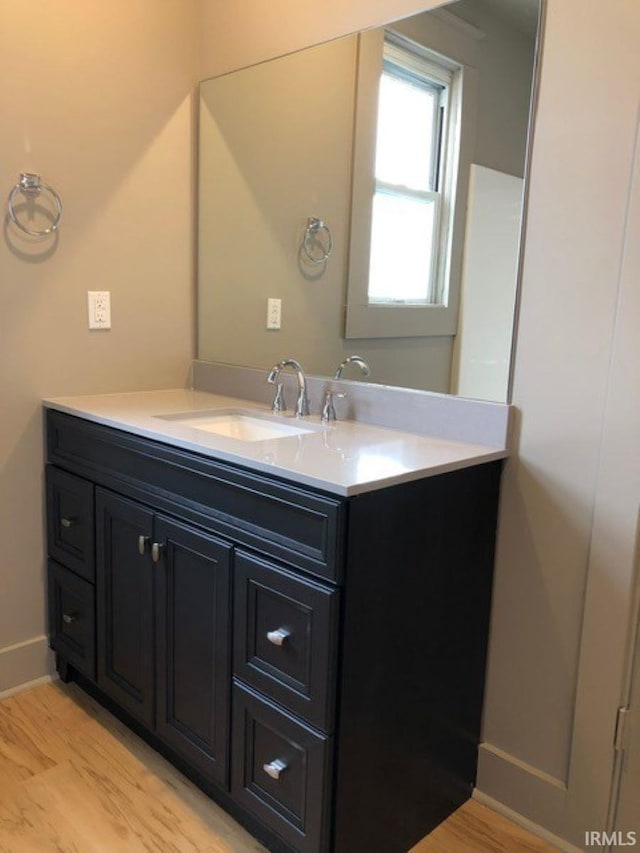 bathroom with vanity and wood-type flooring