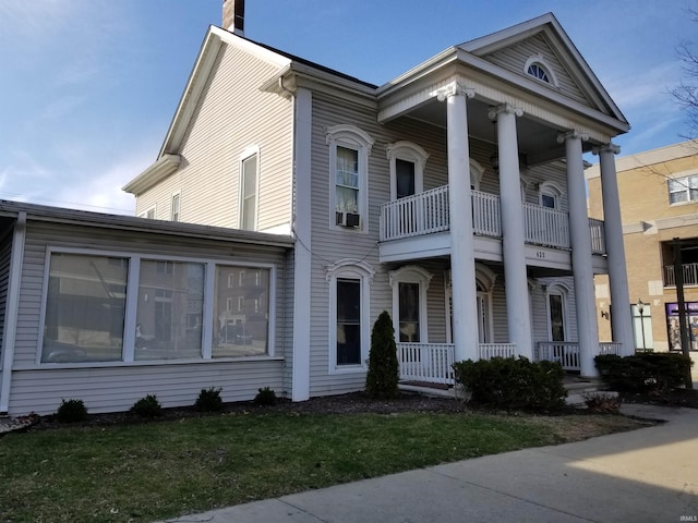 neoclassical / greek revival house with a porch and a balcony