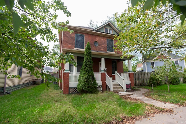 view of front of property with a porch and a front lawn