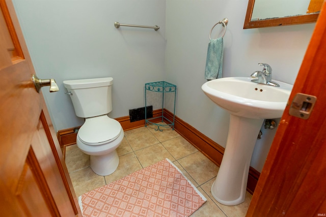 bathroom featuring sink, tile patterned flooring, and toilet