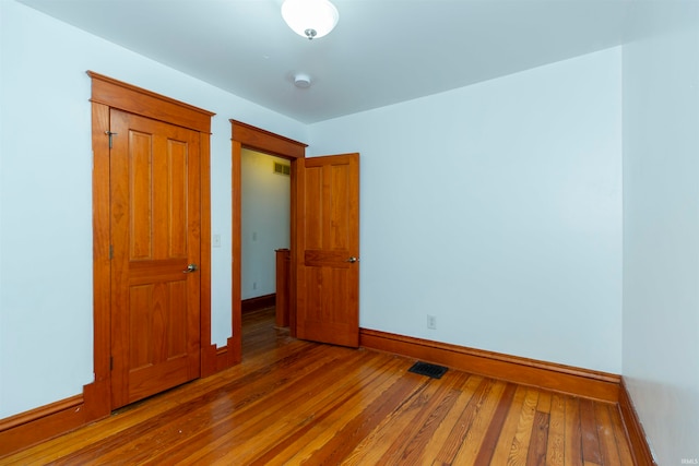 unfurnished bedroom featuring hardwood / wood-style flooring