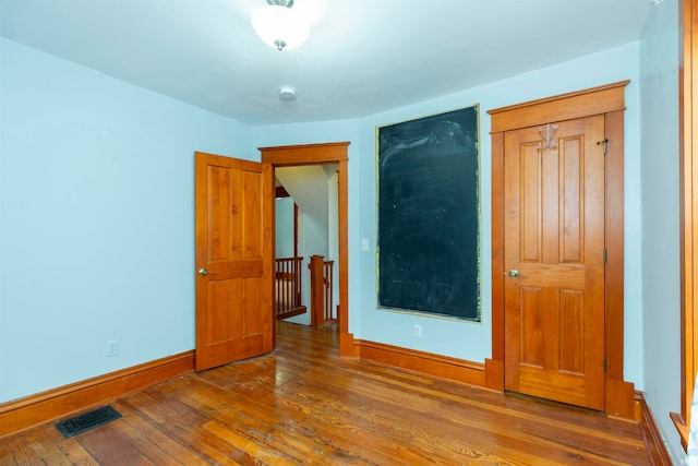 unfurnished bedroom with wood-type flooring