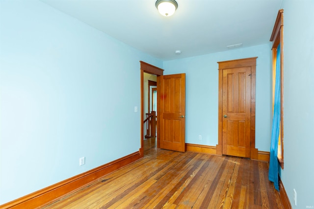 unfurnished bedroom featuring dark hardwood / wood-style floors