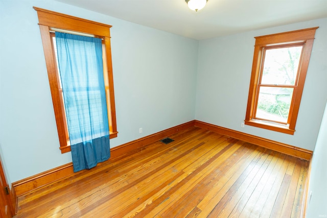 spare room featuring light hardwood / wood-style floors