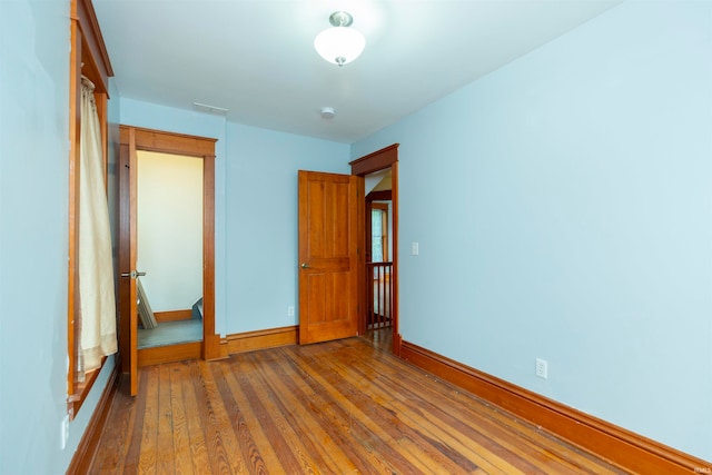 unfurnished bedroom featuring hardwood / wood-style flooring