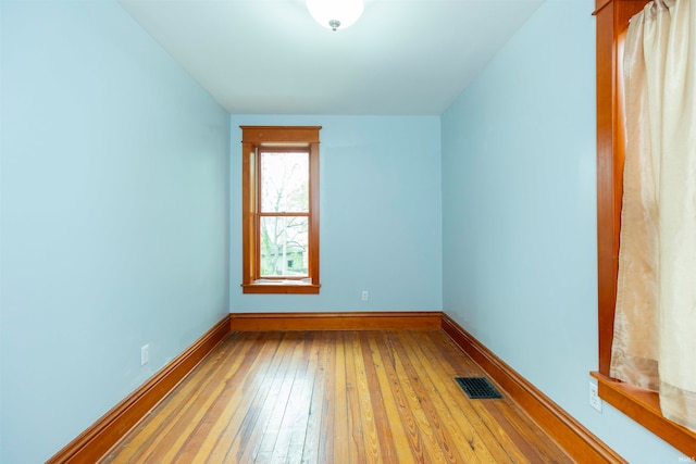 unfurnished room with light wood-type flooring