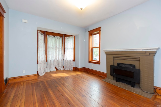 unfurnished living room featuring hardwood / wood-style flooring