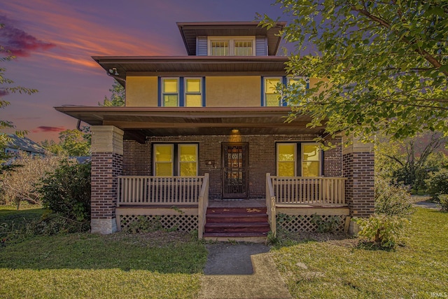 view of front of property featuring a yard and a porch