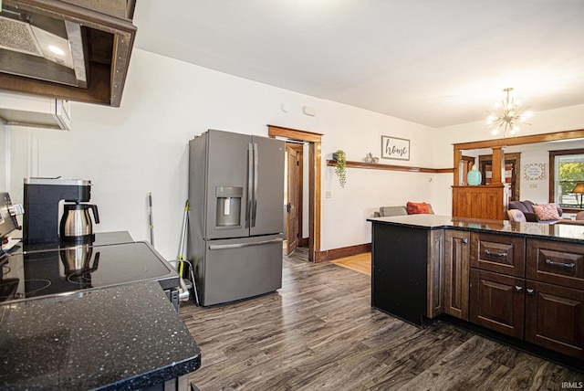 kitchen featuring dark brown cabinets, dark wood-type flooring, stainless steel refrigerator with ice dispenser, a center island, and an inviting chandelier