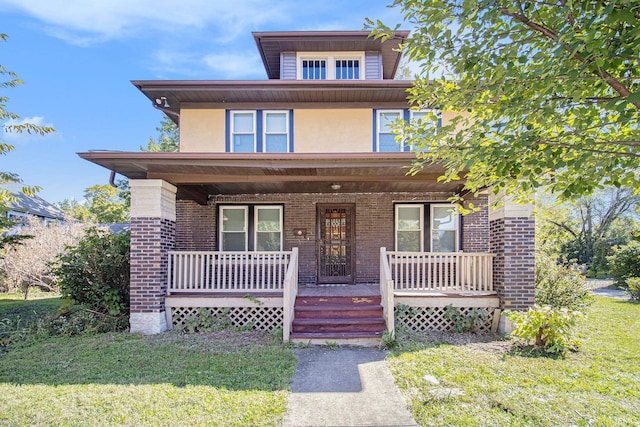 view of front of house featuring a front lawn and covered porch