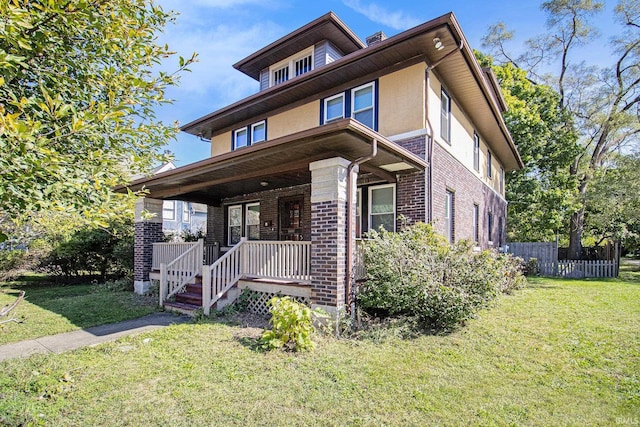 view of front facade with a front lawn and covered porch