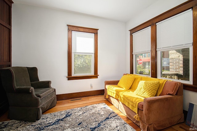 living area featuring radiator heating unit and light hardwood / wood-style flooring