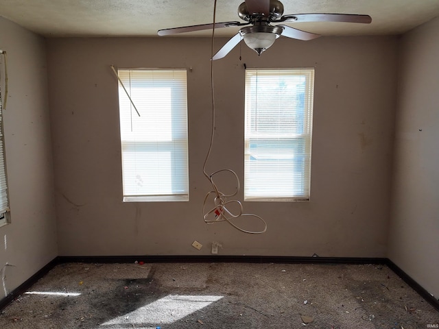 empty room with a textured ceiling and ceiling fan