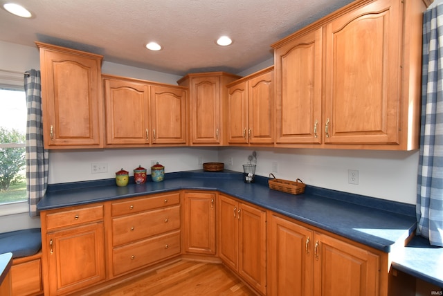 kitchen featuring light hardwood / wood-style floors and a textured ceiling