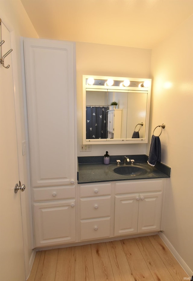 bathroom with vanity and hardwood / wood-style floors