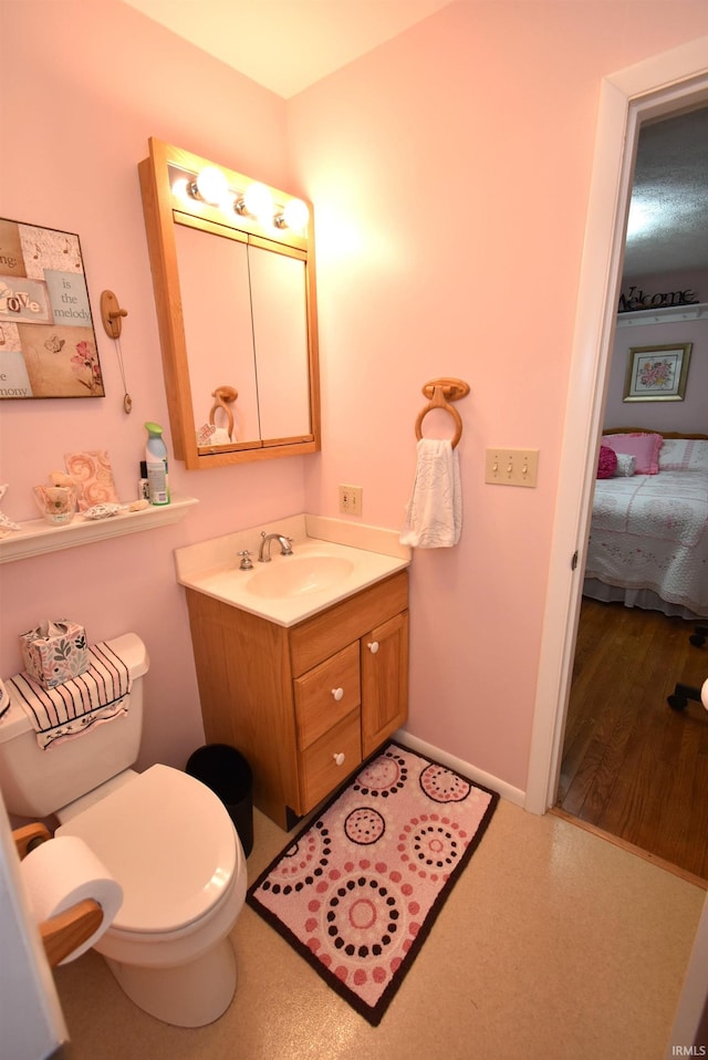 bathroom featuring hardwood / wood-style flooring, vanity, and toilet