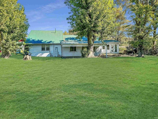 back of property featuring a patio and a lawn