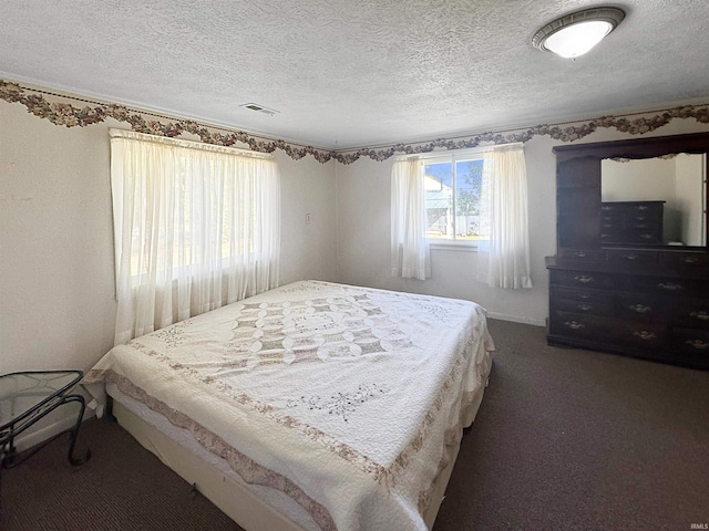 carpeted bedroom featuring a textured ceiling