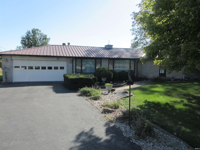 ranch-style home featuring a garage and a front yard