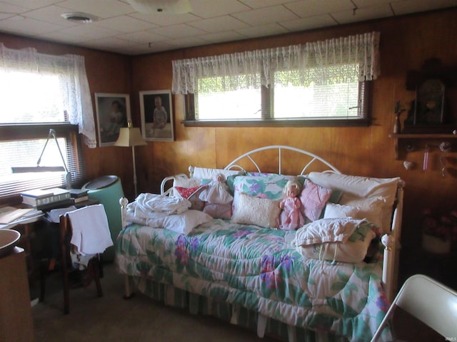 bedroom with wood walls and a paneled ceiling