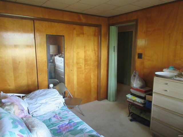 carpeted bedroom with wooden walls