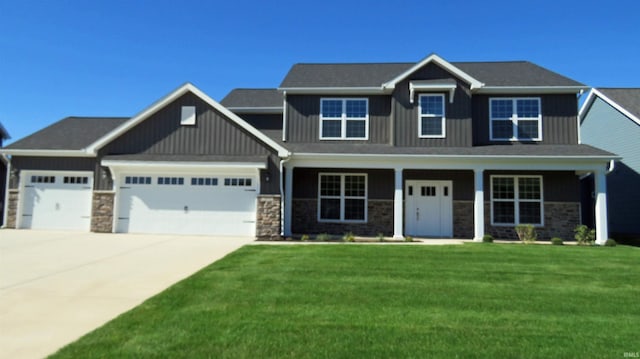 craftsman inspired home featuring a porch, a front yard, and a garage