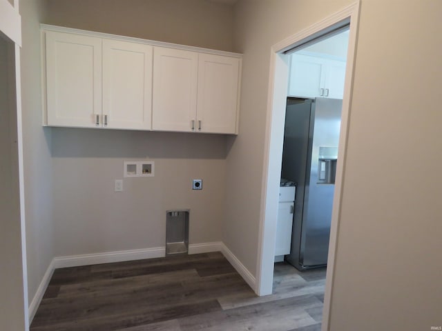 laundry area featuring hookup for an electric dryer, cabinet space, hookup for a washing machine, baseboards, and dark wood finished floors