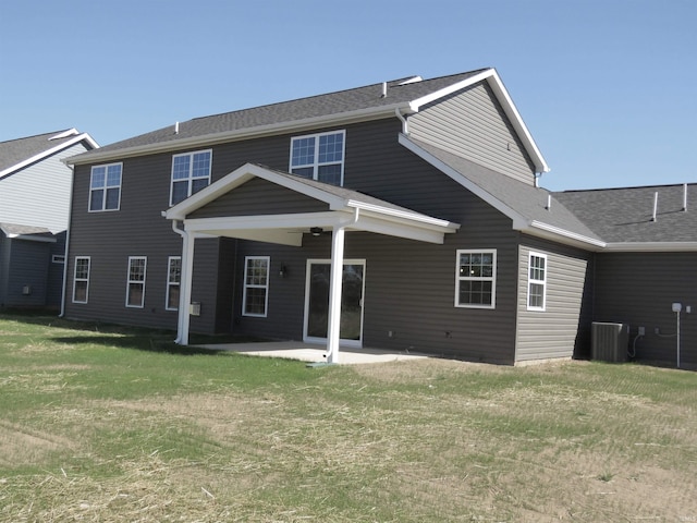 back of house with central AC, a patio, and a yard