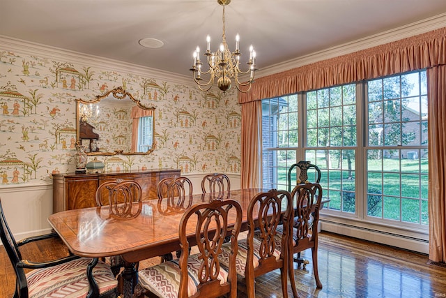 dining area with ornamental molding, a baseboard heating unit, hardwood / wood-style floors, and an inviting chandelier