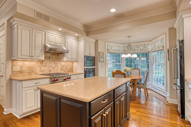 kitchen featuring dark hardwood / wood-style floors, dark brown cabinetry, a center island, and stainless steel appliances