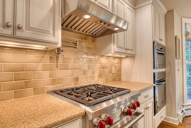 kitchen featuring light stone counters, decorative backsplash, dark hardwood / wood-style floors, stainless steel stove, and extractor fan