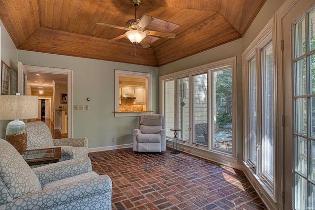 living room featuring ceiling fan, wooden ceiling, and a wealth of natural light